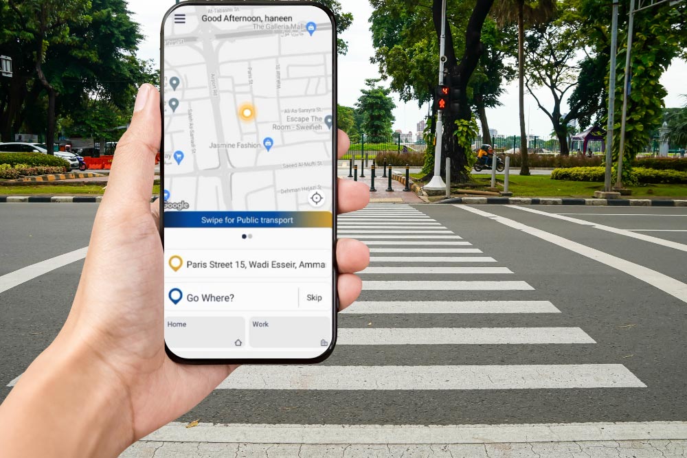 A person using his phone on the zebra crossing 