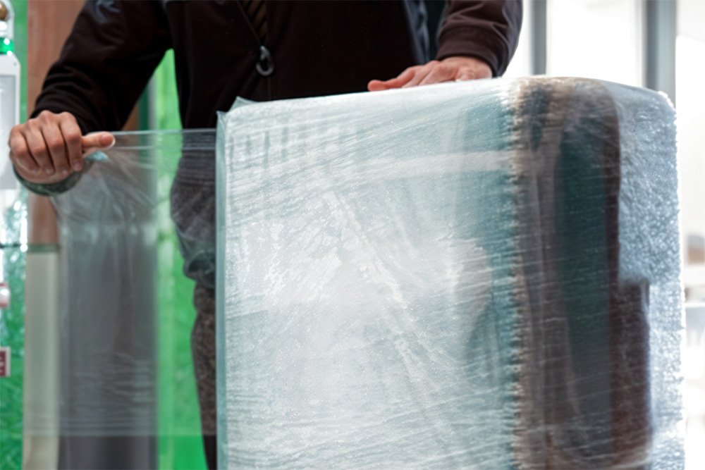 Unwrapping luggage at the airport