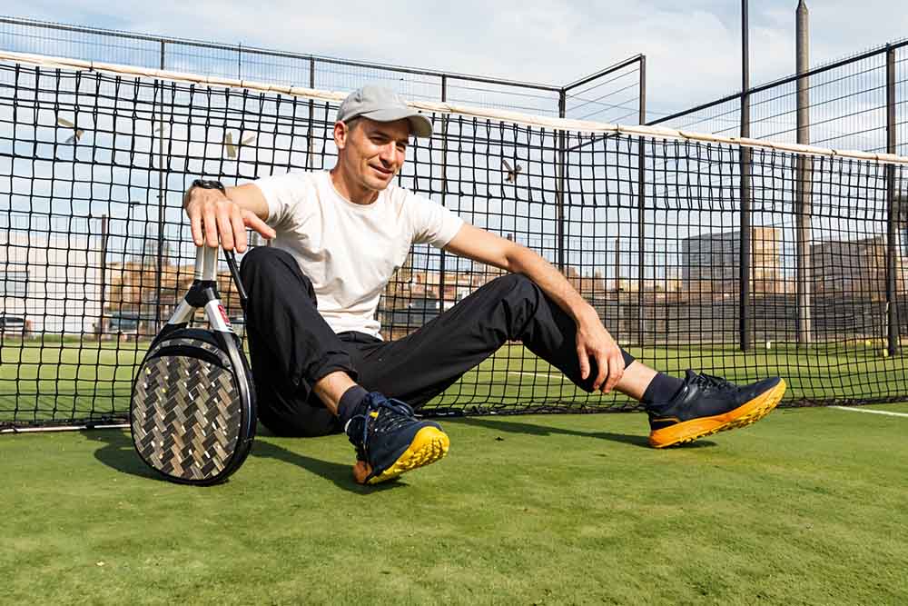 A padel racket with balls in a padel court in Dubai