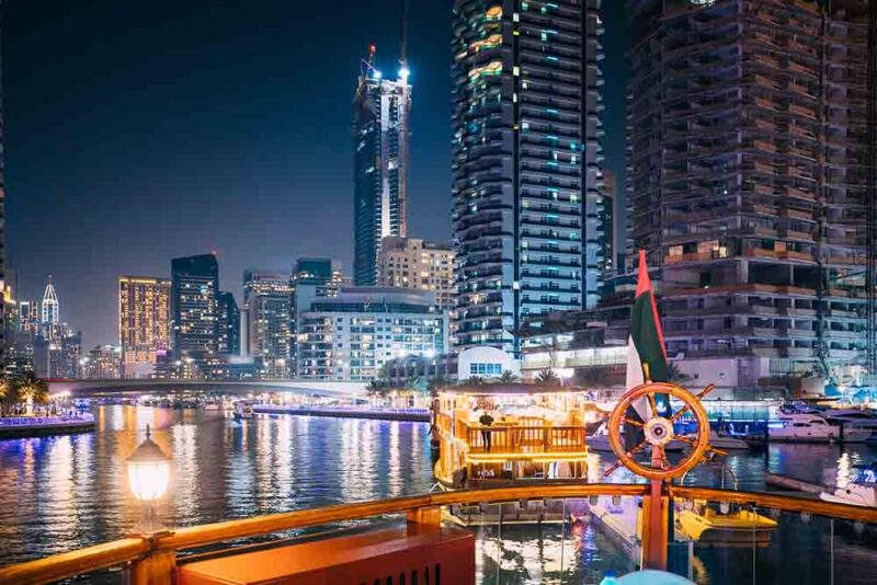 A night view of Dubai from a floating cruise restaurant 