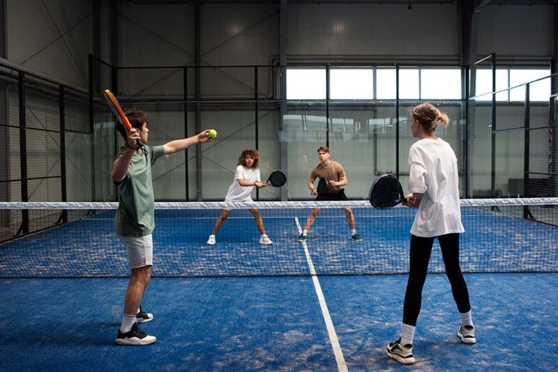 s playing padel at a court in Dubai