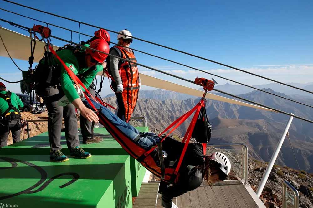 Professional trainers setting up a person for ziplining