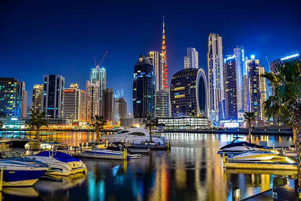 A nice view of Dubai buildings and boats parked 