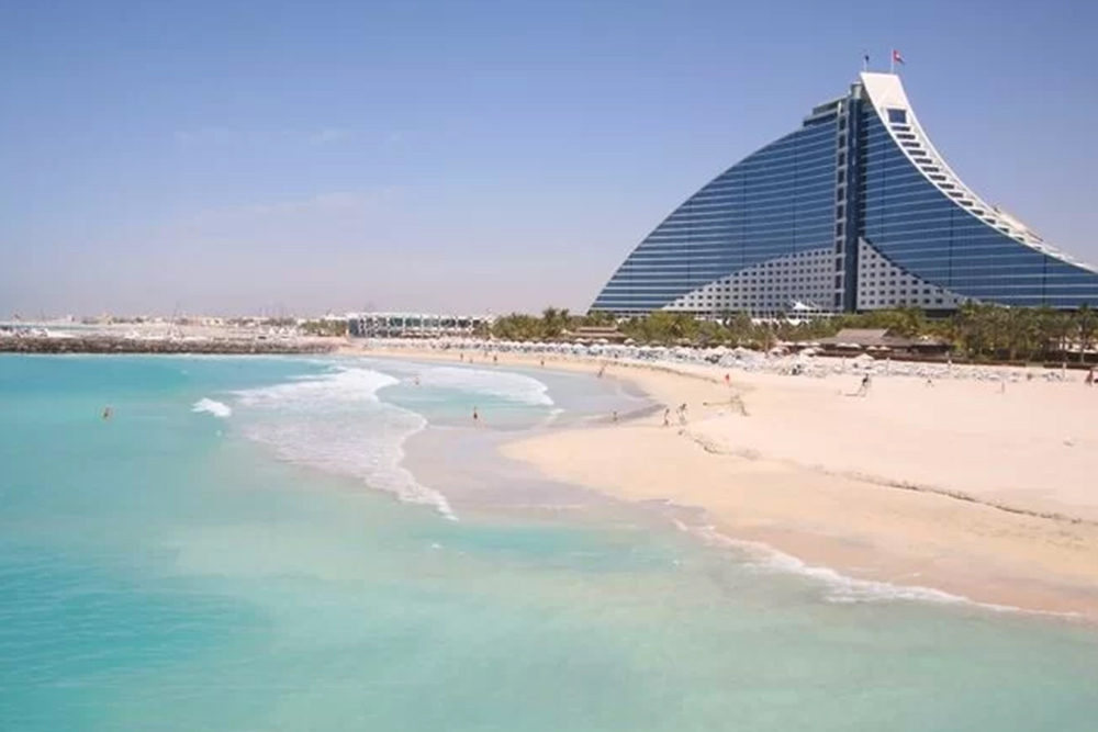  Image of a beachfront with a building in the background 