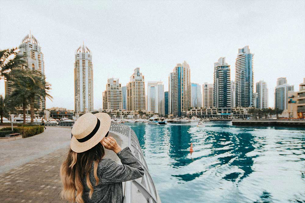 Woman watching Dubai ferry pass by