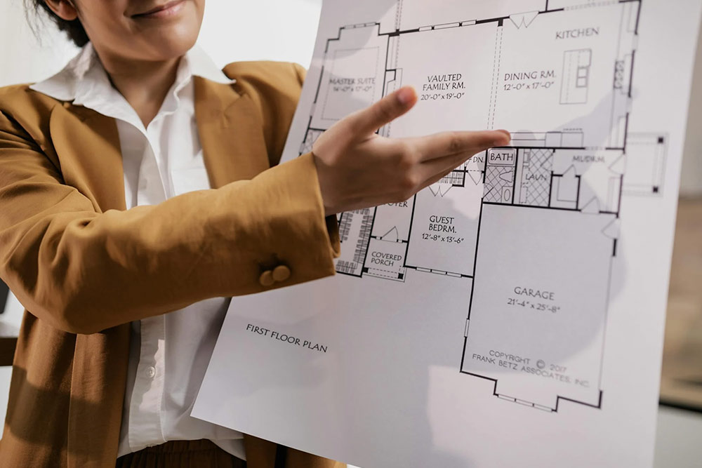 A Realtor Presenting a Blueprint 