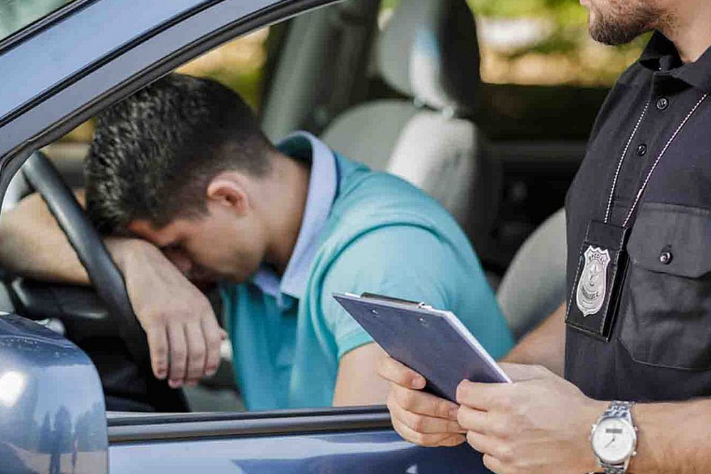 Police giving a fine to a driver in the car