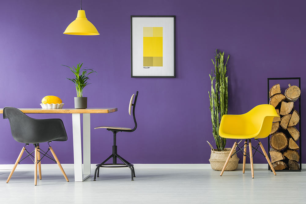 An accent furniture with a purple wall behind