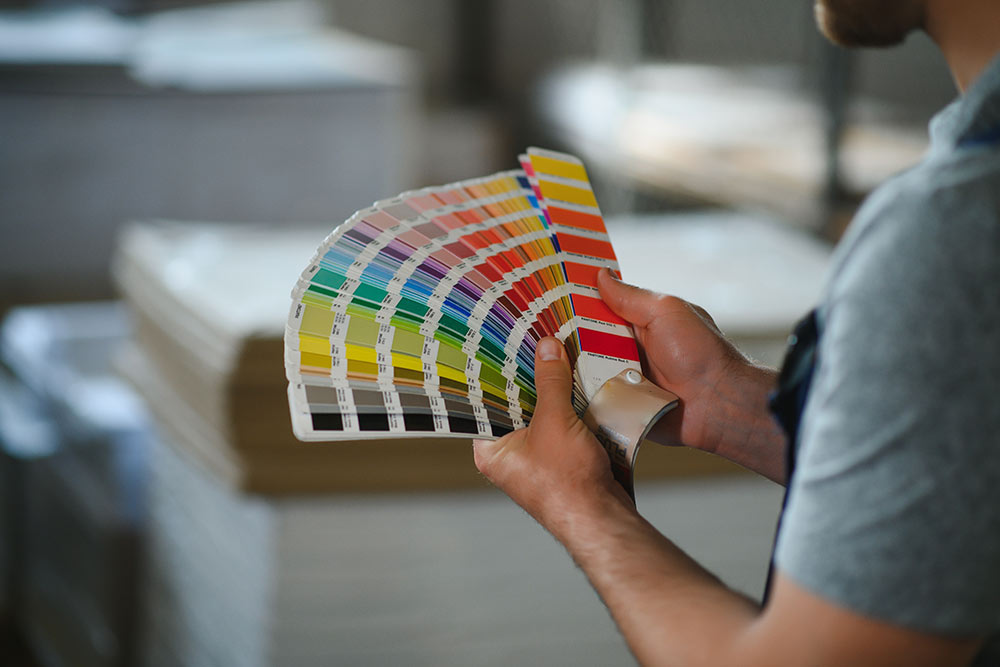 Person selecting the colour from the shade card