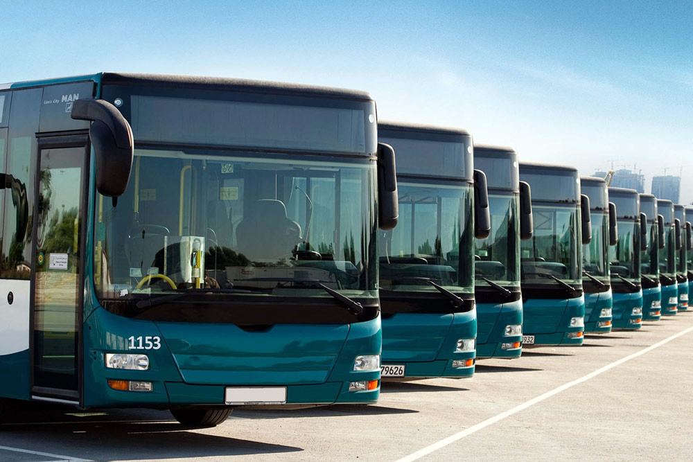 Blue buses in line on a bus stand near al hudayriat island