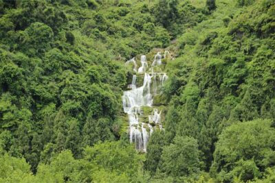 Image of a green valley with a waterfall