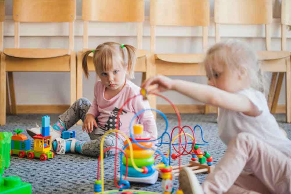 Kindergarten children playing with toys 