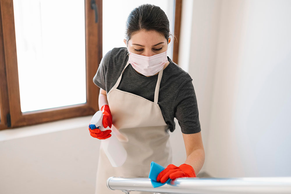 Maid is cleaning a railing