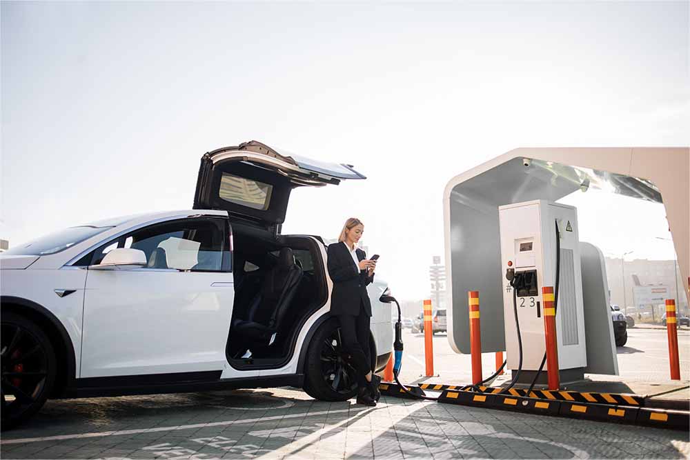 Woman charging ev car in dubai