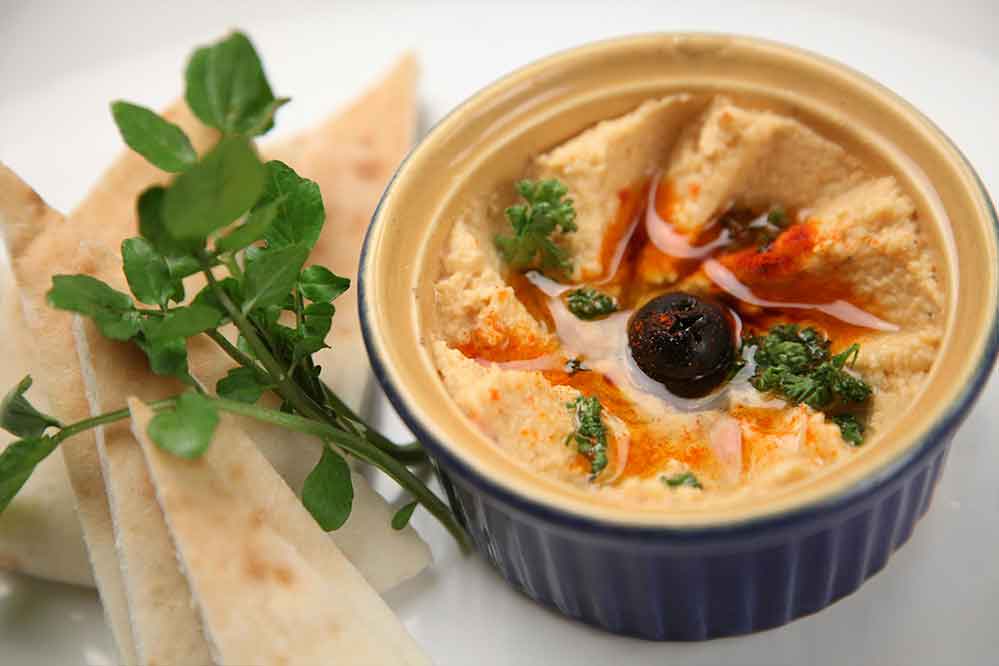 Fresh hummus served with pita bread