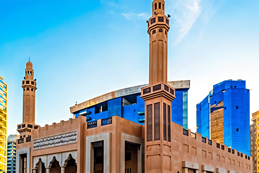 Beige-coloured mosque under blue sky