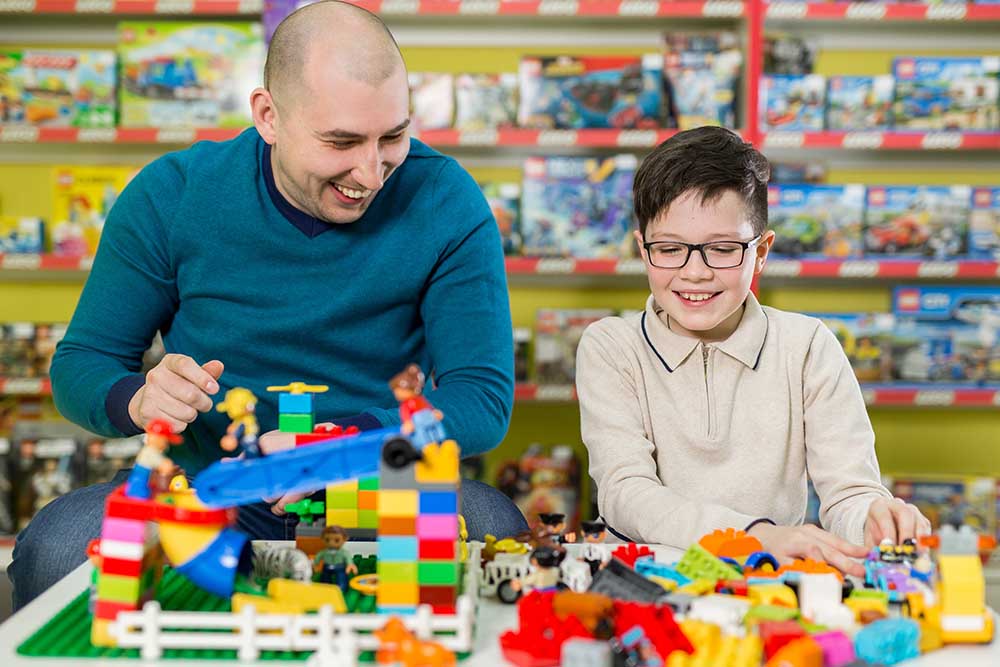 Family playing with LEGO in Dubai toy stores