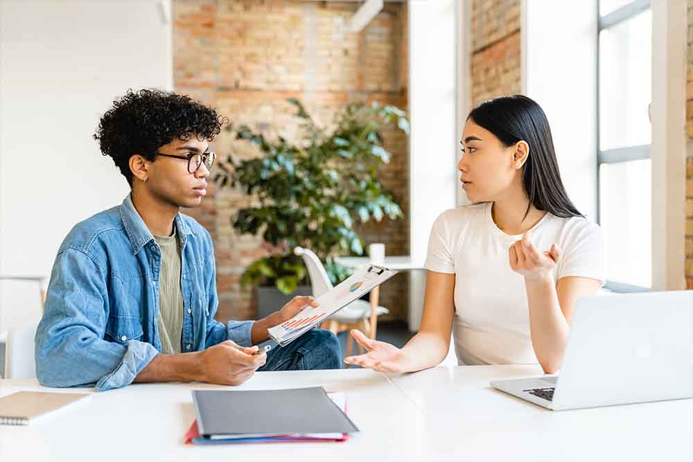 Two people discussing an internship project 