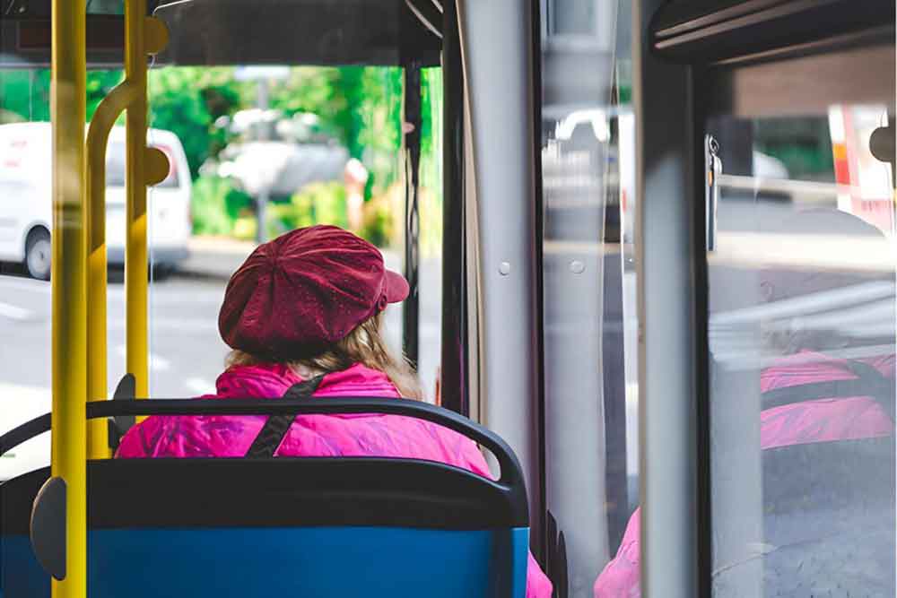 Woman enjoying budget-friendly travel using Dubai public bus