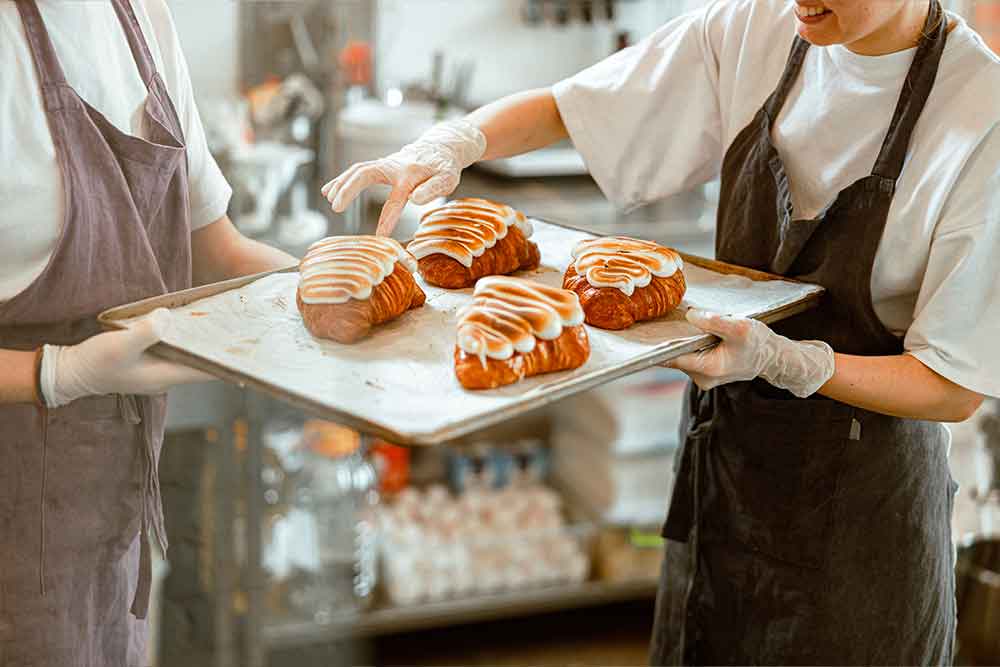 Decorating crossiants in Abu Dhabi bakery