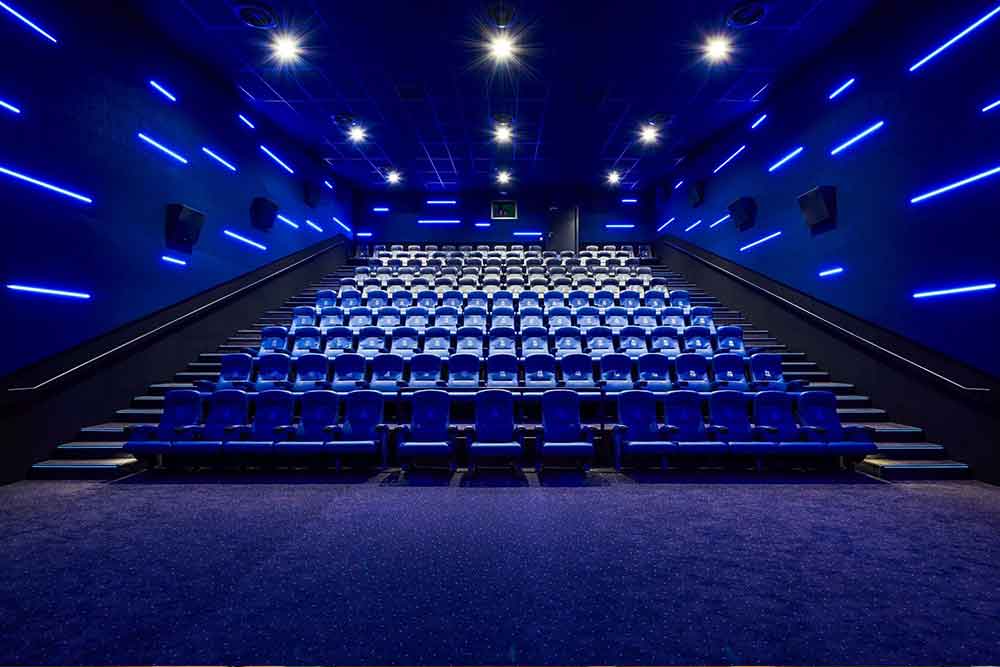 Image of a movie theatre with blue seats 