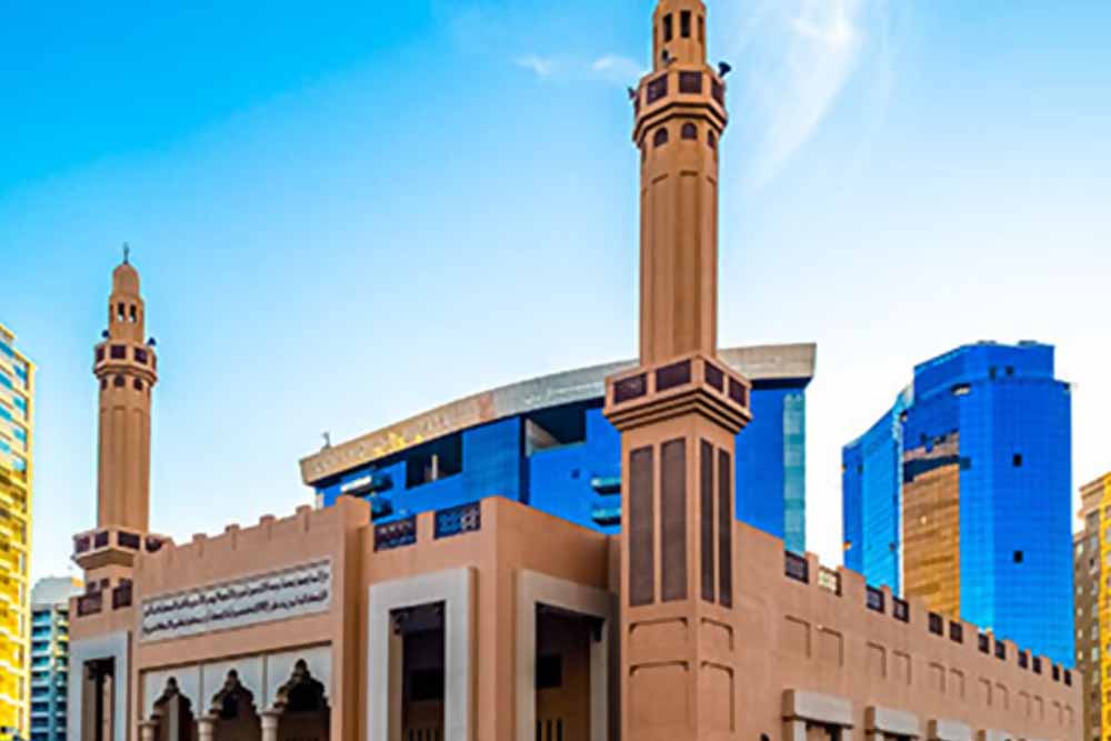 Beige-coloured mosque under blue sky