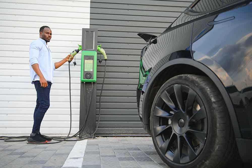 Person charging ev using DEWA ev green charger in Dubai