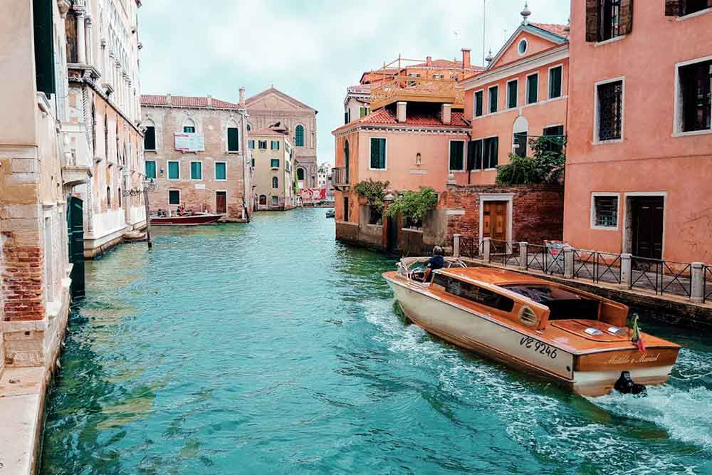 A boat sailing in the lakes of Venice city