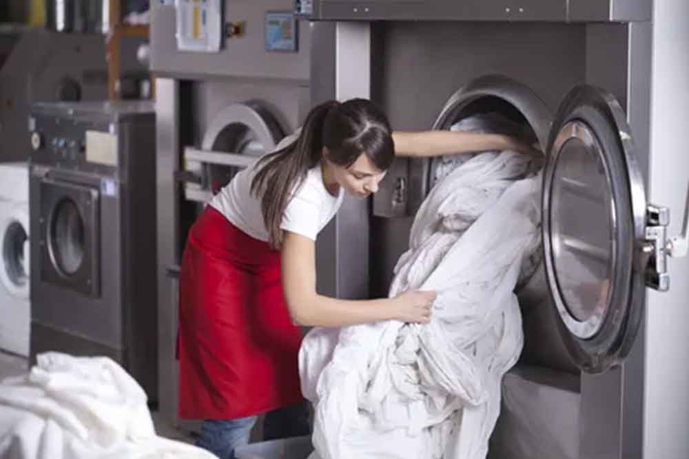 the team at emco deluxe handling your laundry 