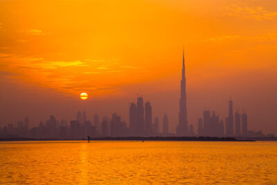 A sea facing high rise in a sunset sky