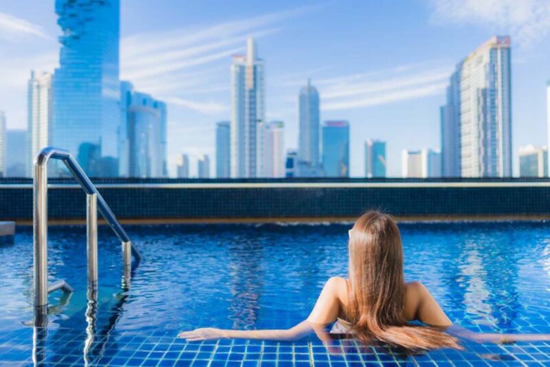 Portrait of beautiful young enjoy around outdoor swimming pool in Dubai