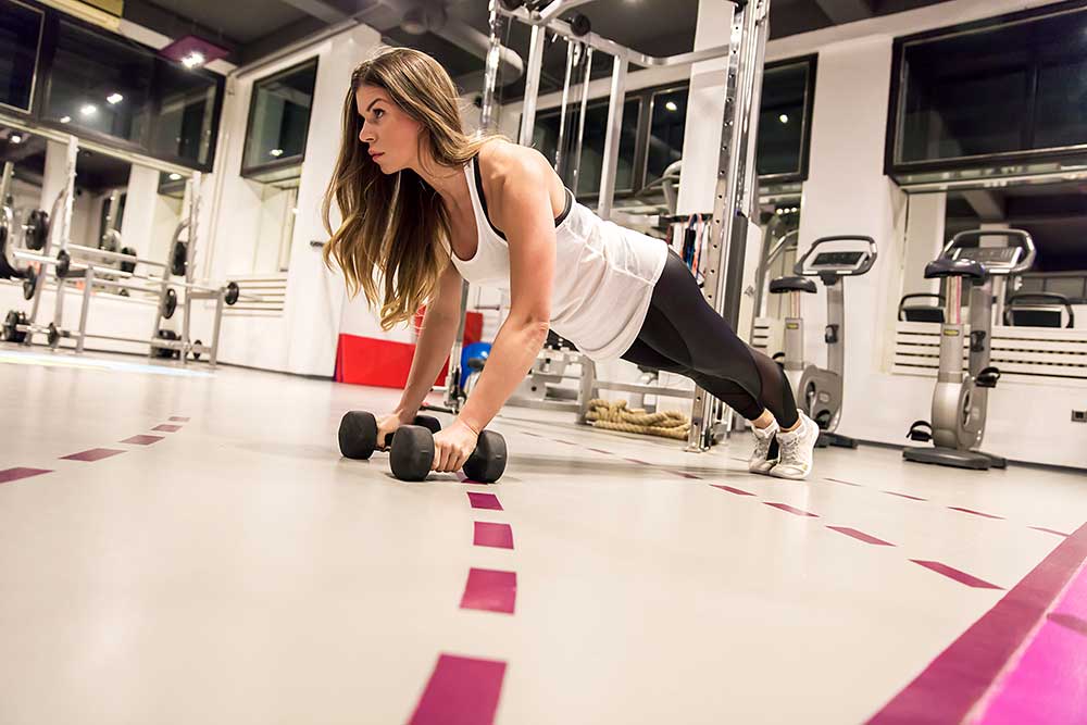 plank exercise with weights a in gym in Dubai