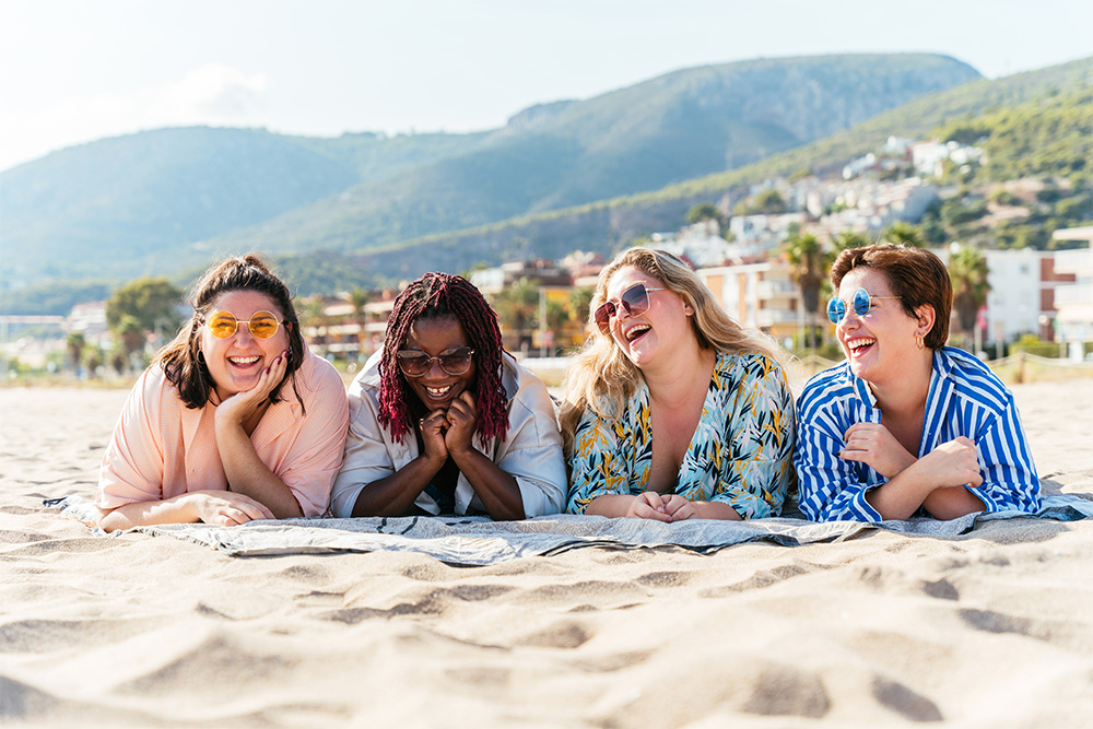 Group of women sunbathing at beach