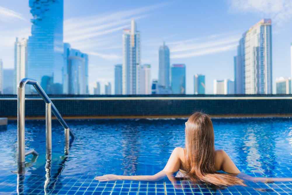 Portrait of beautiful young enjoy around outdoor swimming pool in Dubai 