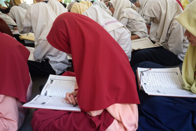 Students reading the Quran in a class