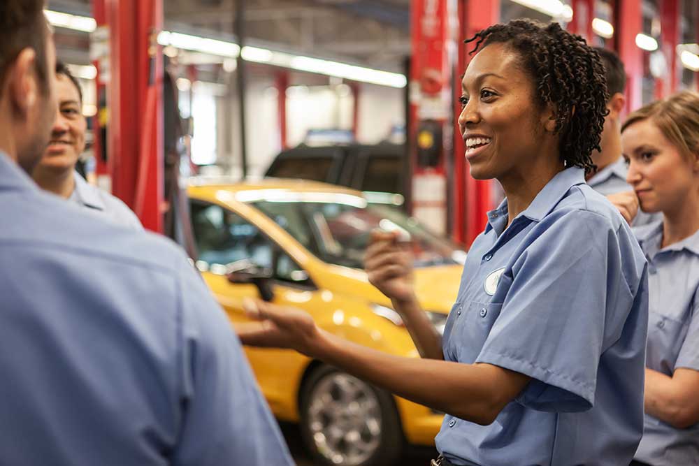 Skilled mechanics at a car garage 