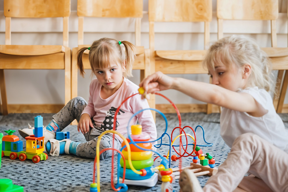 Kindergarten children playing with toys 