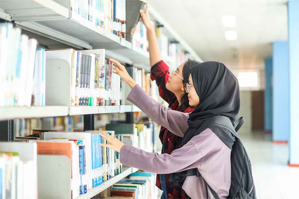 Students searching for books in a bookstore 