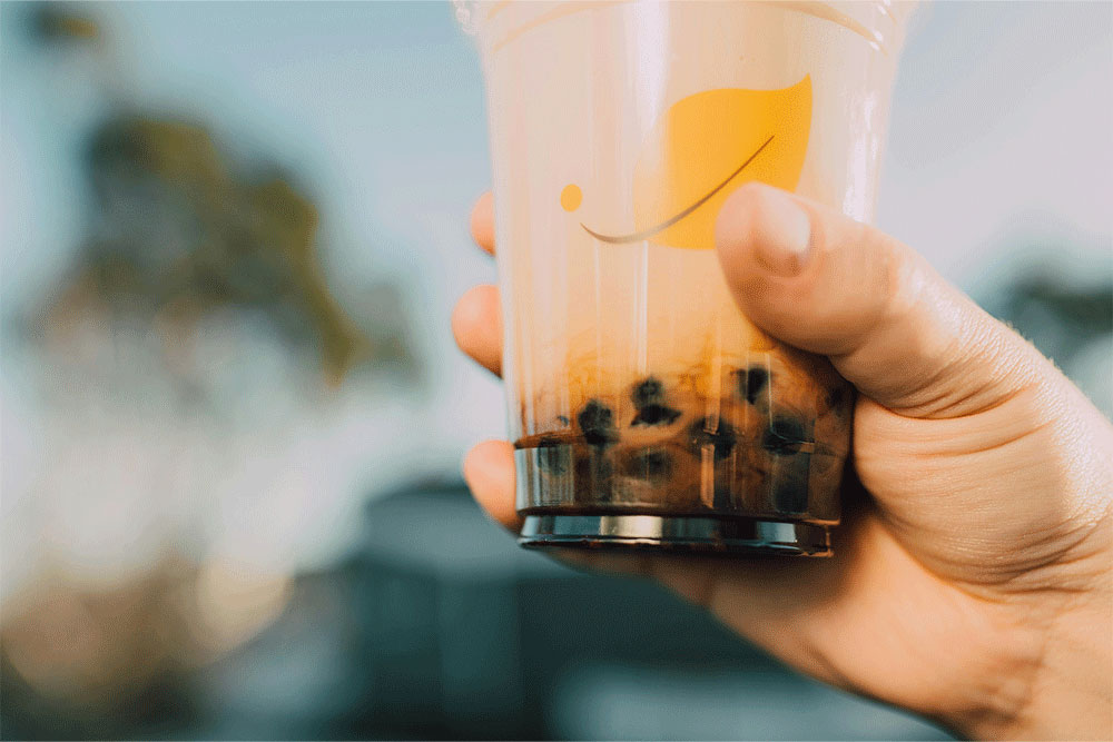 black tapioca pearls sitting at the bottom of a boba cup 