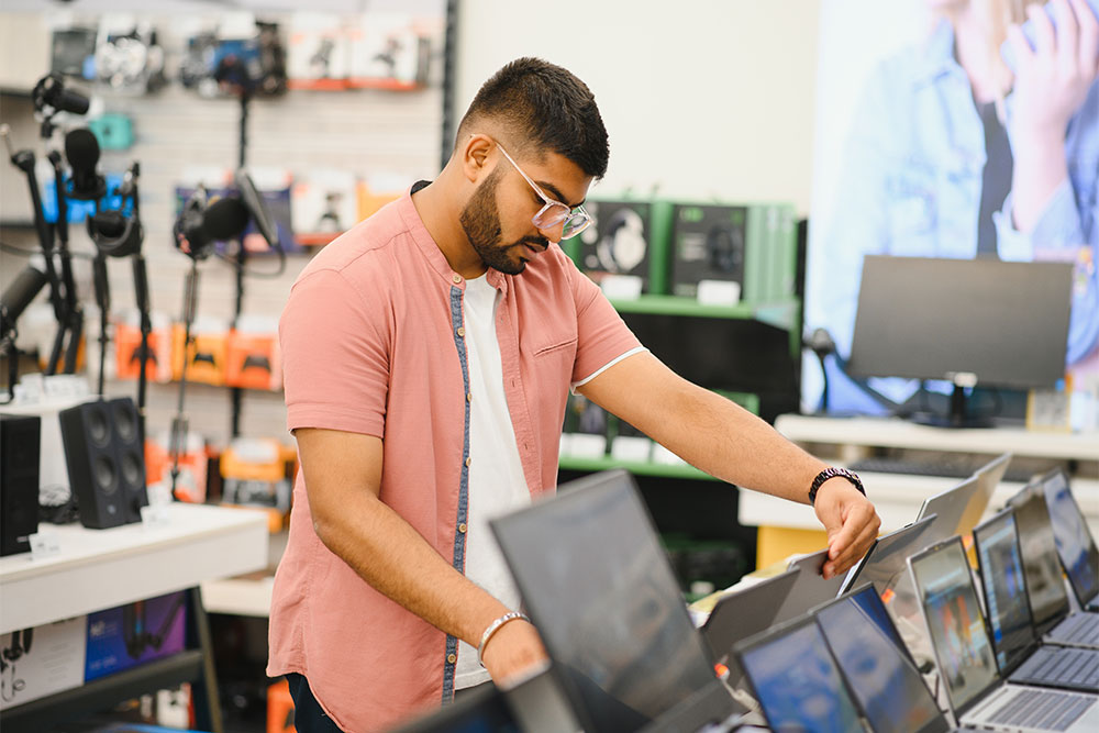 choosing a laptop in an electronic store in Dubai