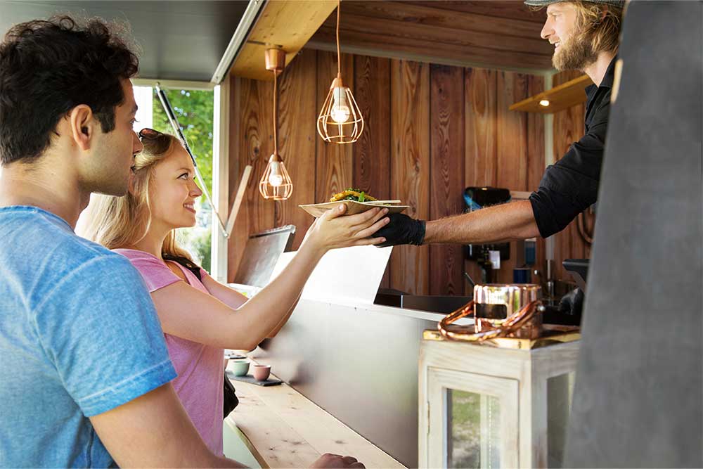 cook in a food truck serving his customers