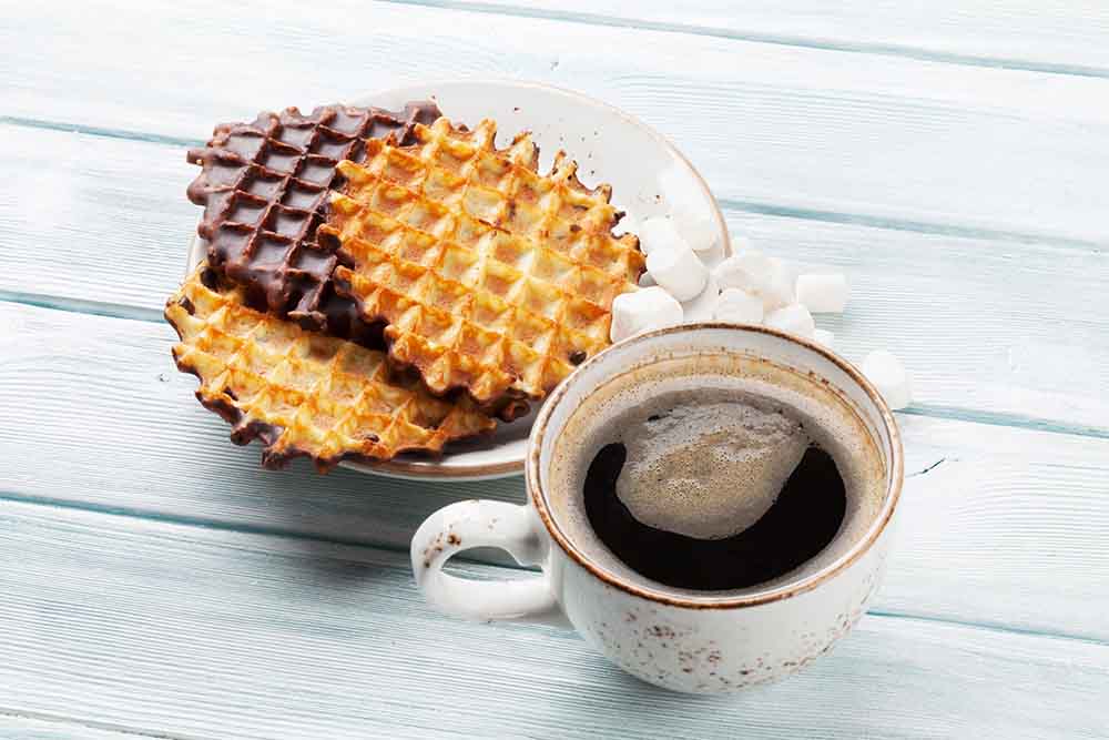 Side view of chocolate rich waffles with fruit toppings