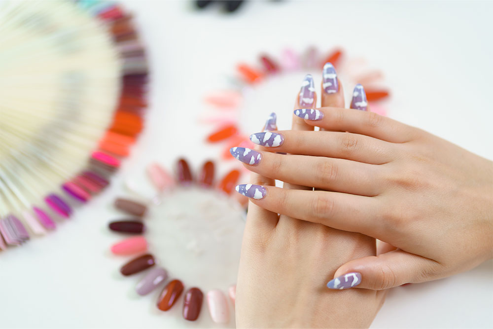 A female hands with nail extensions and colour palettes