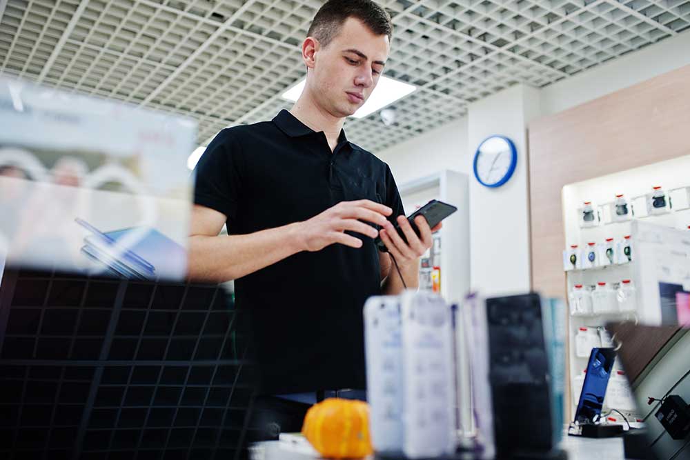 Man checking out a phone in a store