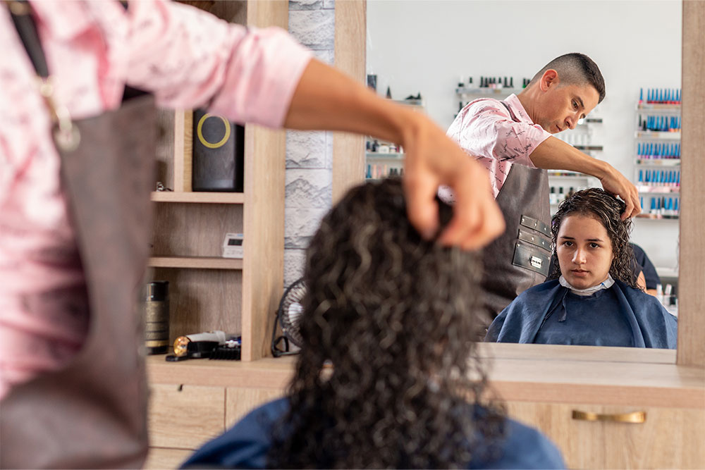  hair stylist working in a hair salon