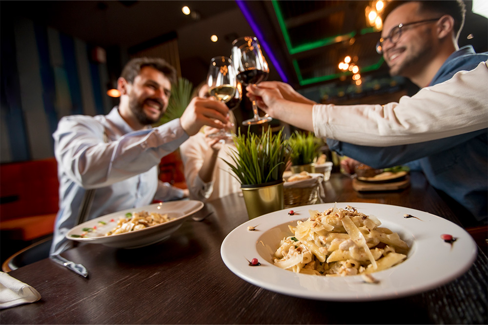 A group of friends enjoying drinks over Italian food