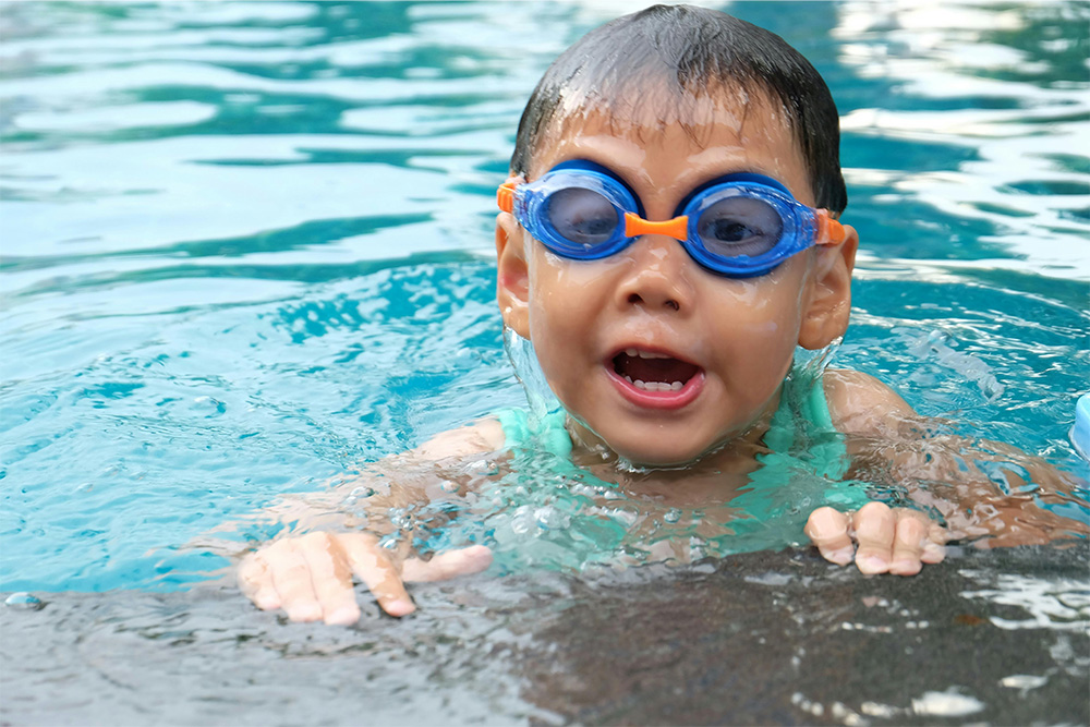 kid enjoying in a swimming pool