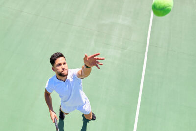 A man catching a tennis ball at a tennis club in Dubai