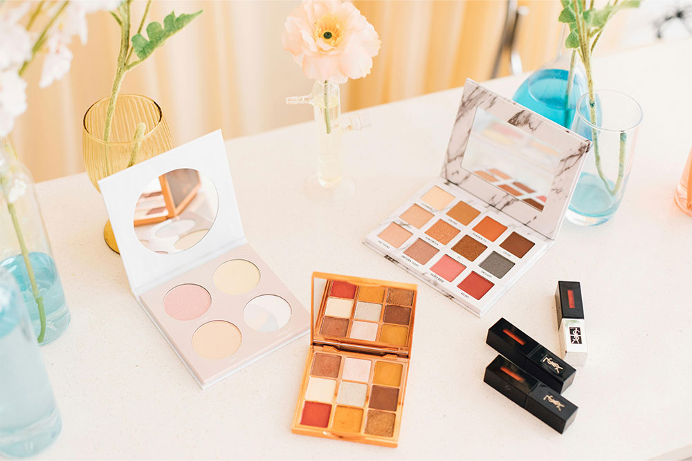 assortment of makeup products on a table