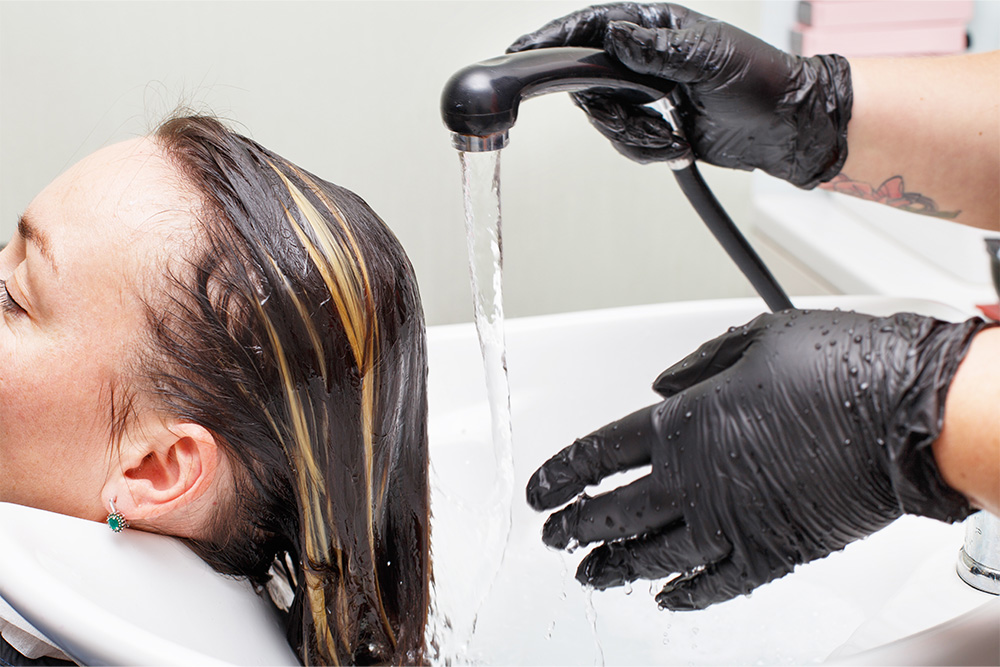 Hair treatment of a woman at Gold & Ash Beauty Salon in Khalifa City